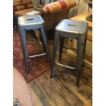 A PAIR OF INDUSTRIAL STEEL STOOLS. (31cm x 31cm x 76cm)