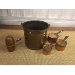 AN ANTIQUE COPPER PAIL Having a wrought iron handle, together with three antique copper saucepans,