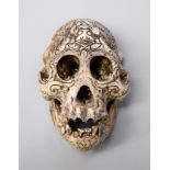 A LATE 19TH/EARLY 20TH CENTURY DAYAK TRIBE HEAD HUNTERS CARVED ORANGUTAN SKULL. (h 12cm x w 20cm x d