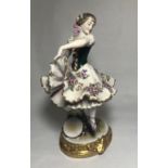 WITHDRAWN A LATE 19TH CENTURY SAMSON GERMAN STATUE OF A DANCING BALLERINA Bearing a gold anchor