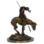AFTER JAMES EARLE FRASER, A BRONZE STATUE Titled 'End of The Trail', on an oval green marble