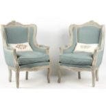 A PAIR OF 19TH CENTURY LOUIS XV DESIGN CARVED WOOD AND PAINTED UPHOLSTERED WING BACK FAUTEUILS