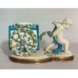 A 19TH CENTURY MINTON PORCELAIN FOR THOMAS GOODE FIGURAL CENTREPIECE Winged cherub pulling a cart