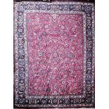 A LARGE TABRIZ WOOLLEN RUG OF CARPET PROPORTIONS With central floral field contained in running
