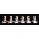 SAMPSON MORDAN, A SET OF FOUR EDWARDIAN NOVELTY SILVER OWL MENU HOLDERS With glass set eyes and