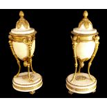 A PAIR OF 19TH CENTURY GILT BRONZE AND WHITE MARBLE CASSOLETTES The lidded tops with pineapple