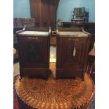 A PAIR OF VICTORIAN DESIGN WALNUT PURDONIUMS With marble tops and carved decoration raised on