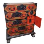 AN EARLY 20TH CENTURY CHINESE RED LACQUERED AND CHINOISERIE DECORATED CHEST With an arrangement of