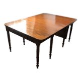 A GEORGE III PERIOD MAHOGANY EXTENDING DINING TABLE With two extra leaves, raised on ring turned