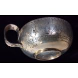 AN EDWARDIAN SILVER PORRINGER The circular shallow form with handle, having engraved decoration of