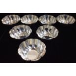 A SET OF SEVEN EARLY 20TH CENTURY SILVER BOWLS Of plain form with fluted edge, marked Mappin & Webb,
