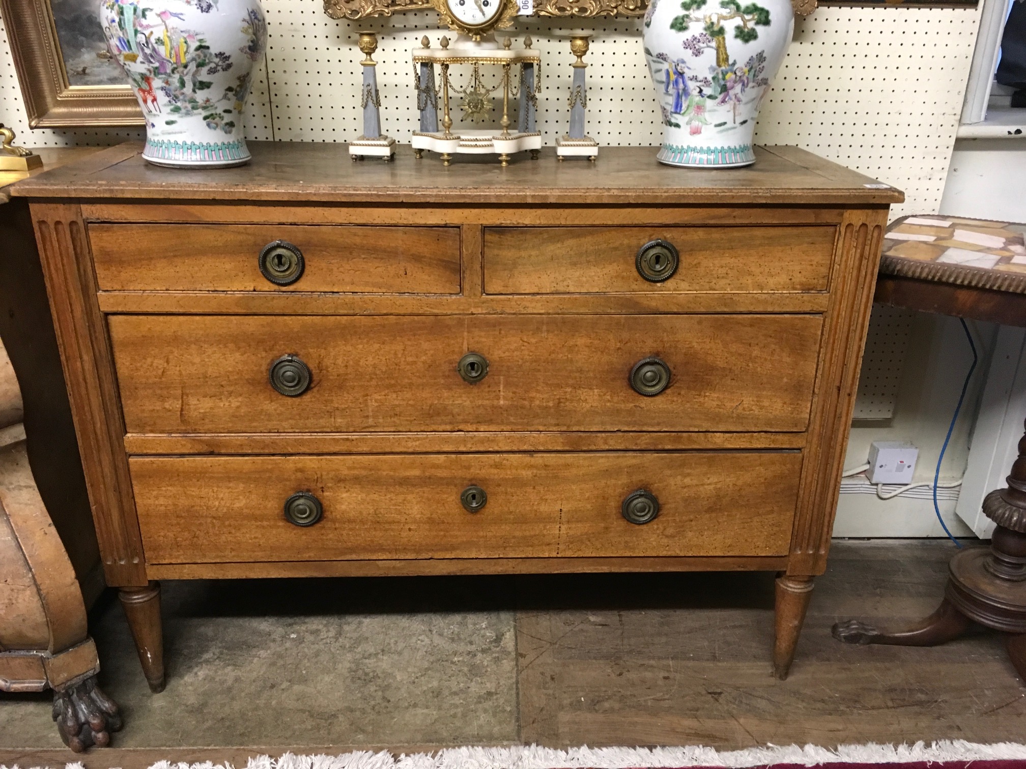 A 19TH CENTURY WALNUT CHEST OF DRAWERS Having two short over long drawers, flanked by fluted