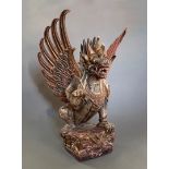 A LATE 19TH/EARLY 20TH CENTURY CARVED INDONESIAN GARUDA STATUE. (h 73cm x w 50cm x d 50cm)