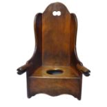 A 19TH CENTURY MAHOGANY CHILD'S ROCKING CHAIR/COMMODE Having a pierced and shaped back. (h 63cm)