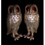 A PAIR OF NOVELTY SILVER OWL PEPPER POTS The detachable heads set with amber glass eyes and embossed