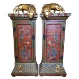A PAIR OF DECORATIVE RED LACQUERED CHINESE PIER CABINETS Having Dog of Fo surmounts over a single