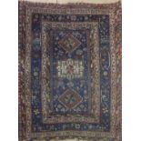 A PERSIAN DESIGN RUG With geometric and zoomorphic motifs, on a blue ground contained within six