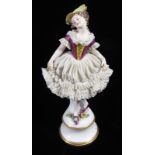 DRESDEN, A 20TH CENTURY PORCELAIN FIGURE OF A LADY Dressed in lace and raised on a circular base,