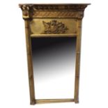 A REGENCY CARVED GILTWOOD MIRROR With Lions head masks over column and a coat of arms.