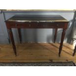 AN EARLY 19TH CENTURY MAHOGANY TWO DRAWER WRITING TABLE With brass handles over reeded legs,