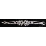 A PLATINUM AND DIAMOND BRACELET The arrangement of brilliant and baguette cut diamonds forming a