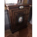 A 19TH CENTURY WALNUT AND EBONY FRENCH PIER CABINET The single door with Paris porcelain plaques and