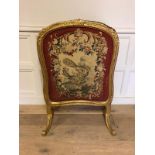 A 19TH CENTURY FIRE SCREEN The giltwood frame inset with a rise and fall tapestry embroidery of