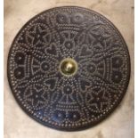 A LEATHER AND BRASS STUD TRIBAL SHIELD With deer skin lining. (diameter 50cm)