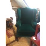 A GEORGIAN DESIGN WING ARMCHAIR Newly upholstered in green velvet, raised on square chamfered