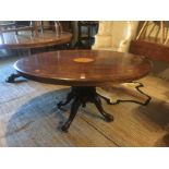 A VICTORIAN MAHOGANY AND INLAID LOO TABLE Supported on four turned columns, raised on carved legs.