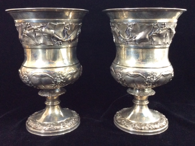 A PAIR OF GEORGIAN SILVER BALUSTER FORM GOBLETS With a wide band of leaves and berries, hallmarked