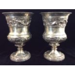 A PAIR OF GEORGIAN SILVER BALUSTER FORM GOBLETS With a wide band of leaves and berries, hallmarked