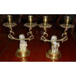 A PAIR OF 19TH CENTURY BRASS CANDLESTICKS Modelled as lions holding shields. (h 27cm)