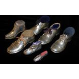 A COLLECTION OF FOUR EDWARDIAN NOVELTY SILVER SHOE PIN CUSHIONS Each having a wooden base, three