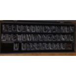 A VINTAGE CASED SET OF PRINTING BLOCKS Full alphabet and numbers, together with a quantity of