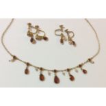 A VINTAGE 9CT GOLD, GARNET AND SEED PEARL NECKLACE Pearl and pear cut garnet drops, together with an