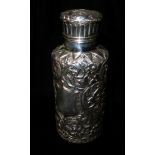 AN EARLY 20TH CENTURY SILVER CYLINDRICAL SCENT BOTTLE With embossed scrolled decoration,