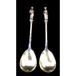 A PAIR OF VICTORIAN SILVER FIGURAL SERVING SPOONS The finials cast as classical figures, one holding