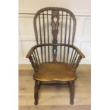 A 19TH CENTURY ASH AND ELM HOOP BACK WINDSOR CHAIR Having a pierced splat back over saddle seat,