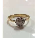 A VINTAGE 18CT GOLD AND DIAMOND CLUSTER RING The arrangement of round cut diamonds on a plain gold