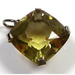 A VINTAGE WHITE METAL AND CITRINE PENDANT The faceted square cut stone held in a plain white metal