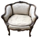 A 19TH CENTURY FRENCH TUB ARMCHAIR With finely carved walnut and parcel gilt frame, upholstered