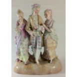 A GERMAN VOLKSTED PORCELAIN FIGURAL GROUP Gent and two maidens wearing 18th Century apparel, bearing