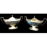 A PAIR OF GEORGIAN SILVER BOAT FORM SAUCE TUREENS With classical urn finials, reeded handles and