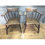 A PAIR OF UNUSUAL 19TH CENTURY SMOKER'S BOW CHAIRS With spindle backs over solid saddle seats,