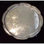 A LARGE VICTORIAN SILVER SALVER Having a scalloped and pierced border with beaded edge and