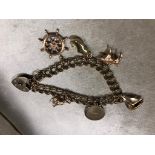 A 9CT GOLD CHARM BRACELET FANCY LINKS WITH SIX CHARMS ATTACHED. WEIGHT 25.4G