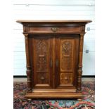 ANTIQUE STYLE WALNUT CUPBOARD WITH SINGLE DRAWER, WITH CARVED FLORAL SCROLL PATTERNS AND CARVED