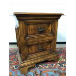WALNUT BEDSIDE TABLE WITH TWO DRAWERS AND DECORATIVE HANDLES RAISED ON PLINTH VERY GOOD CONDITION