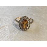 A 9CT GOLD AND CITRINE DRESS RING SET IN A OVAL SHAPE SETTING SIZE N